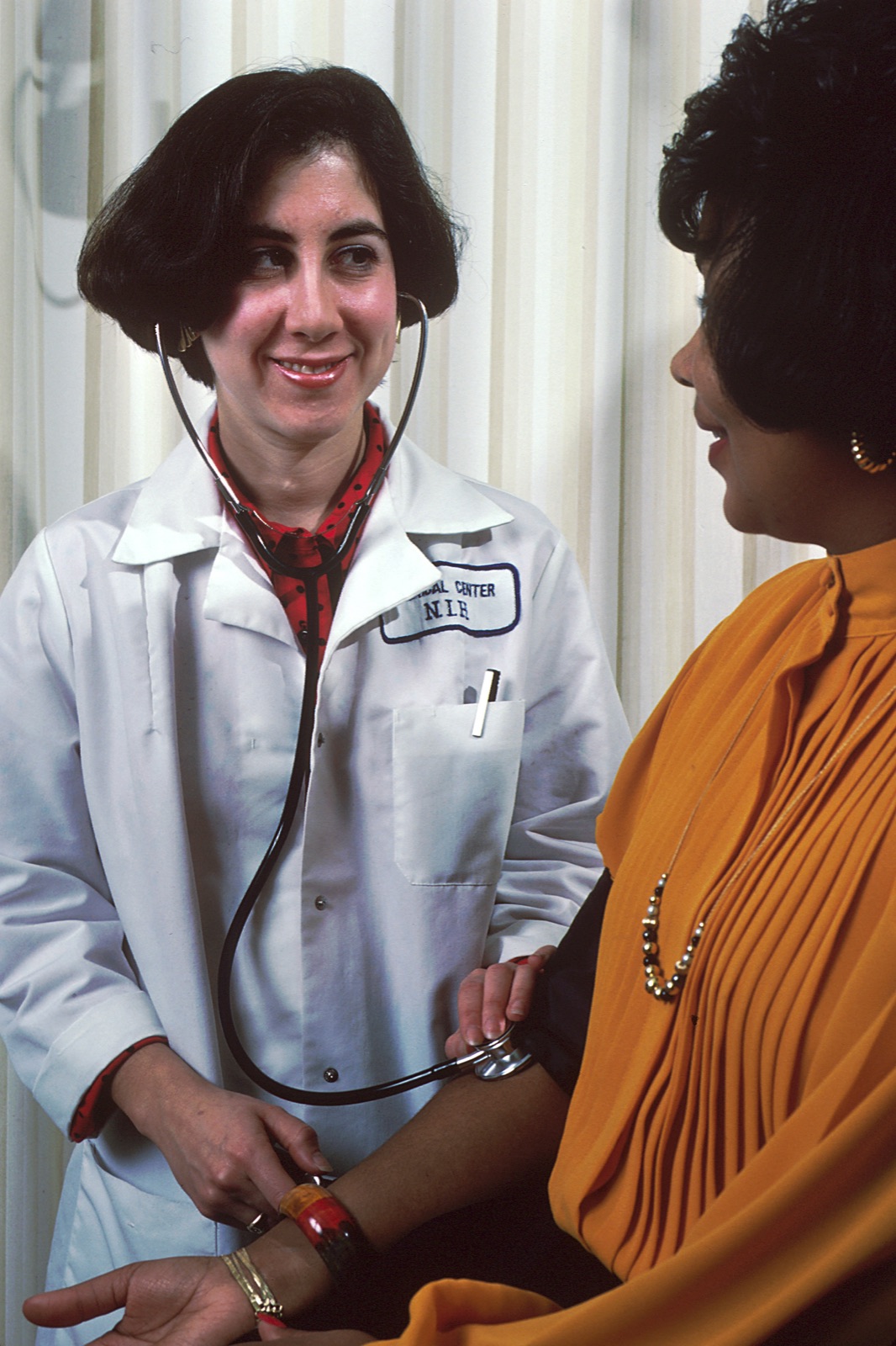 A provider checks a woman’s blood pressure